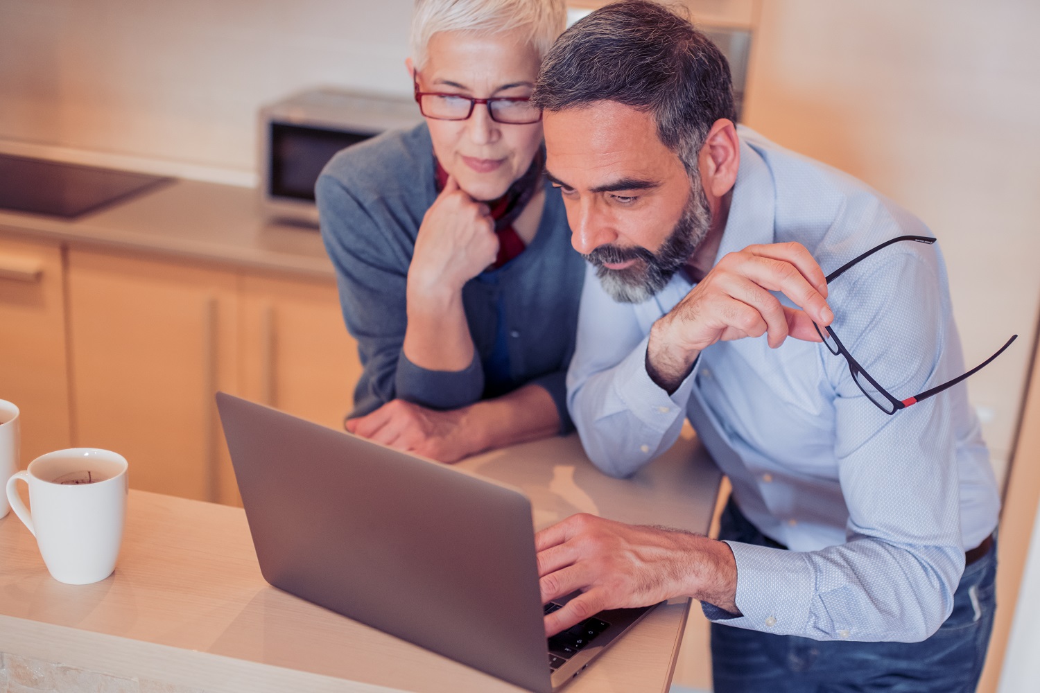 Mature,Couple,Watching,Something,On,Laptop,At,Home.